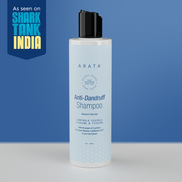 Arata Anti-Dandruff Shampoo bottle with Shark Tank India logo on a blue background